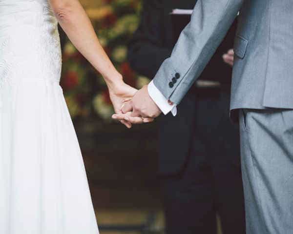 A couple holding hands - Professional Interpretation services at events on the spot - a wedding