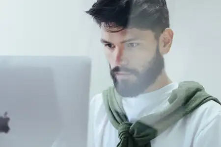 A young man working at a computer monitor