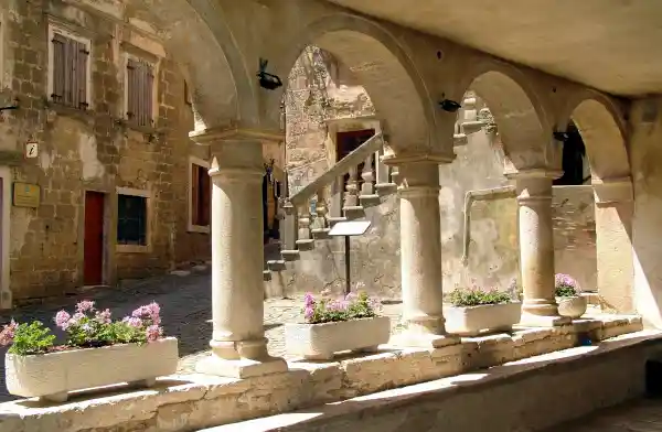 A portico with stone columns and arches in Dalmatia - Croatian translation