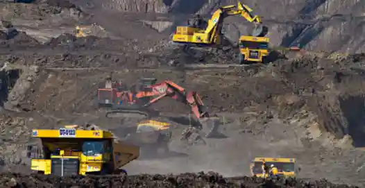 Large mechanical diggers at work in a quarry or open-cast mine - specialized expertise in document translation