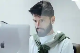 A young man working at a computer