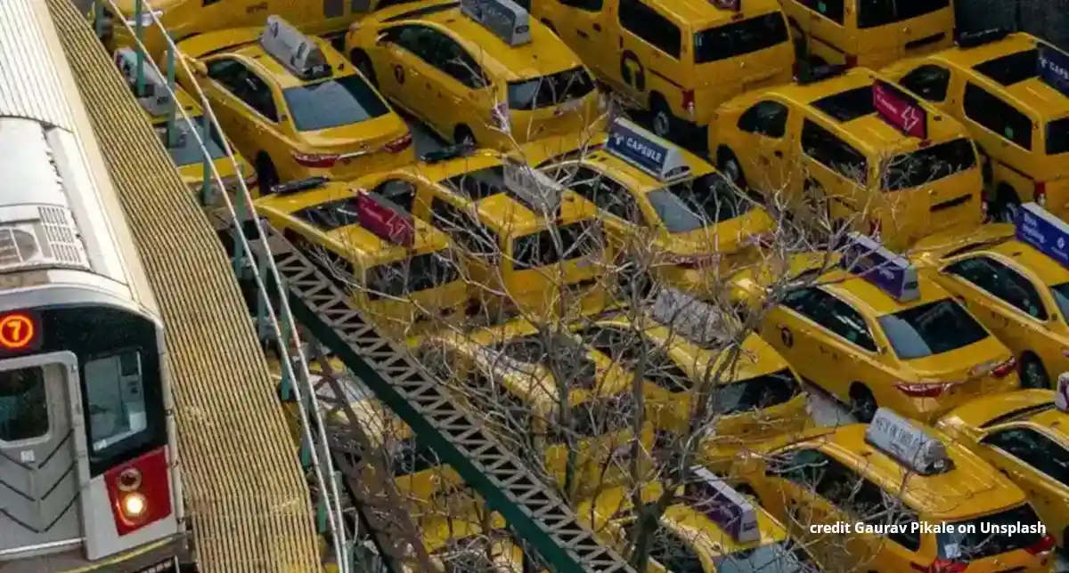 A suburban train passing over a huge taxi jam